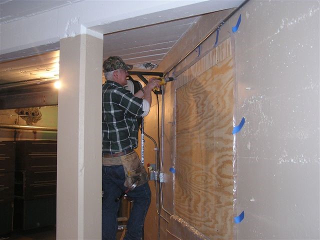 GNRHS volunteer Doug Complin applies the fasteners that hold the plywood in place.  