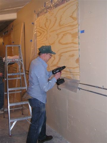 Larry Schrenk put some muscle into sealing the window.