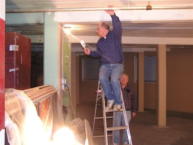 Jim Dick and John Thomas put the finishing touches on the ceiling.