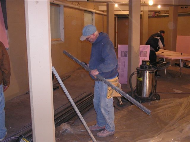 Doug Complin prepares material for window framing