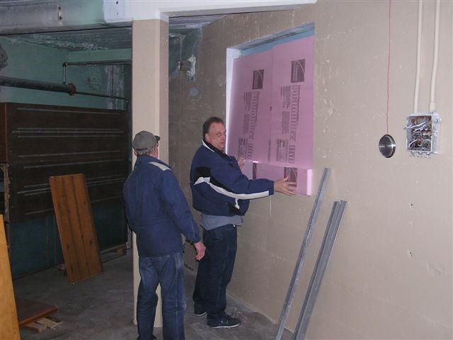 Larry Schrenk and Gary Wildung cut foam for the windows.