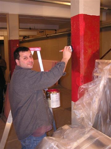 Mike Borkan helps with the painting.