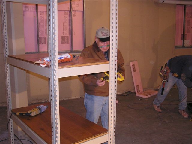 John Oliver takes measurements for the floor layout plan.